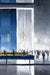 Harold Brauls piece from the Coffee Shop Series - 191747 portrays a lively, urban street scene in a tall lobby, featuring sketch-like figures, a large blue wall, and yellow pendant lights.