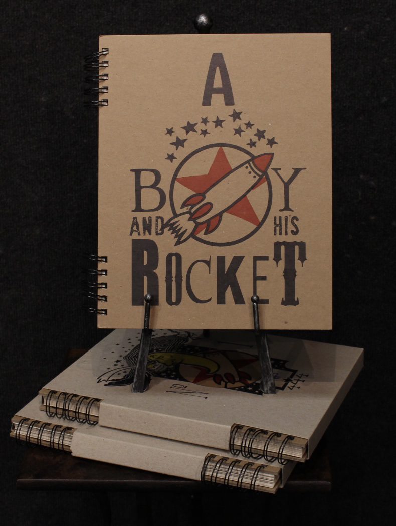 A Boy And His Rocket book on display by Markus Pierson, for sale at Marcus Ashley Gallery.