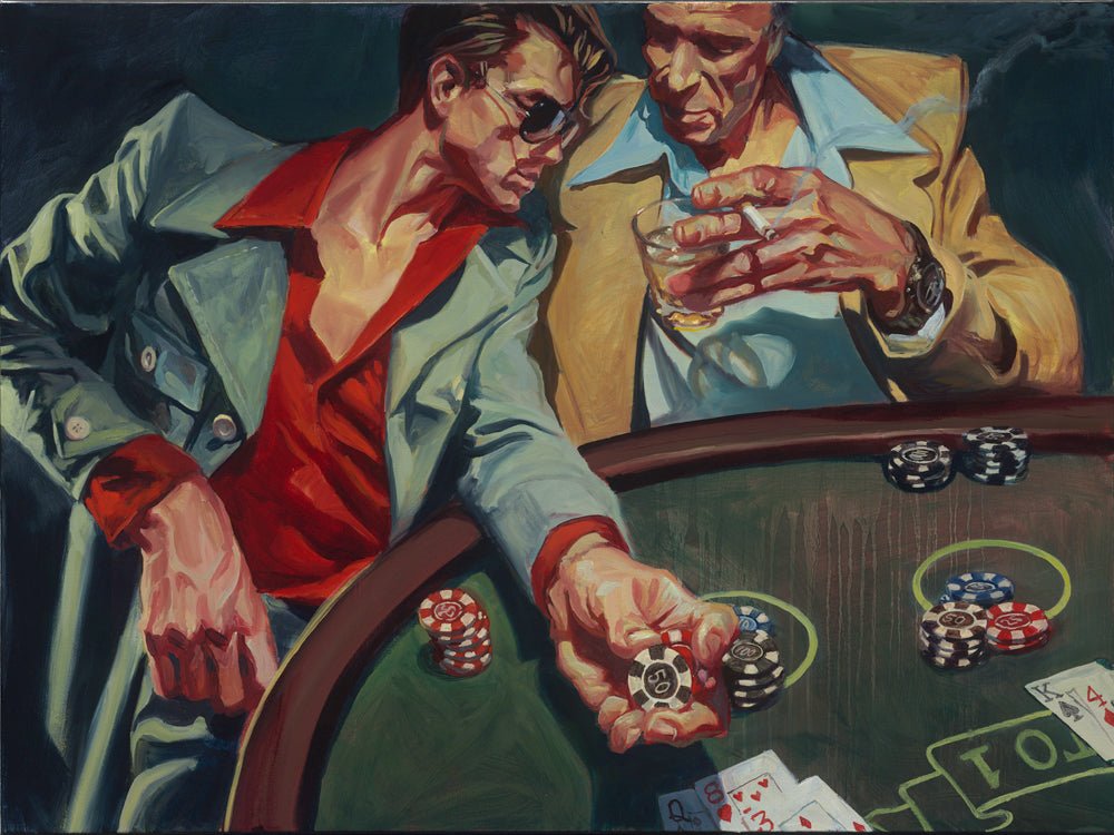 Two men in stylish clothing sit at a green felt table, playing An Educated Guess. One, in sunglasses and a red shirt, holds poker chips as the other leans in with a drink. Playing cards and poker chips are scattered on the table.