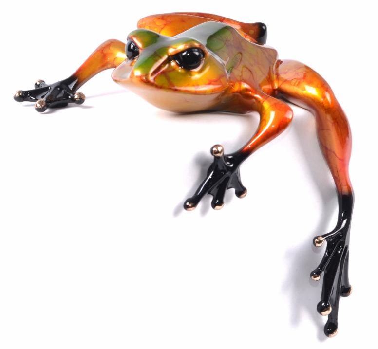 Diego is a vibrant orange and green metallic frog sculpture with detailed glossy textures, large black eyes, and elongated limbs ending in webbed feet. It features an extended leg that adds to its dynamic, lifelike appearance.
