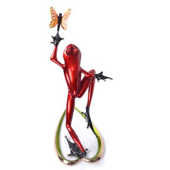 A shiny, red Frogman sculpture of an upright frog reaching for an orange butterfly stands charmingly balanced on green, heart-shaped lily pads, reminiscent of the whimsical Be Mine sculpture.