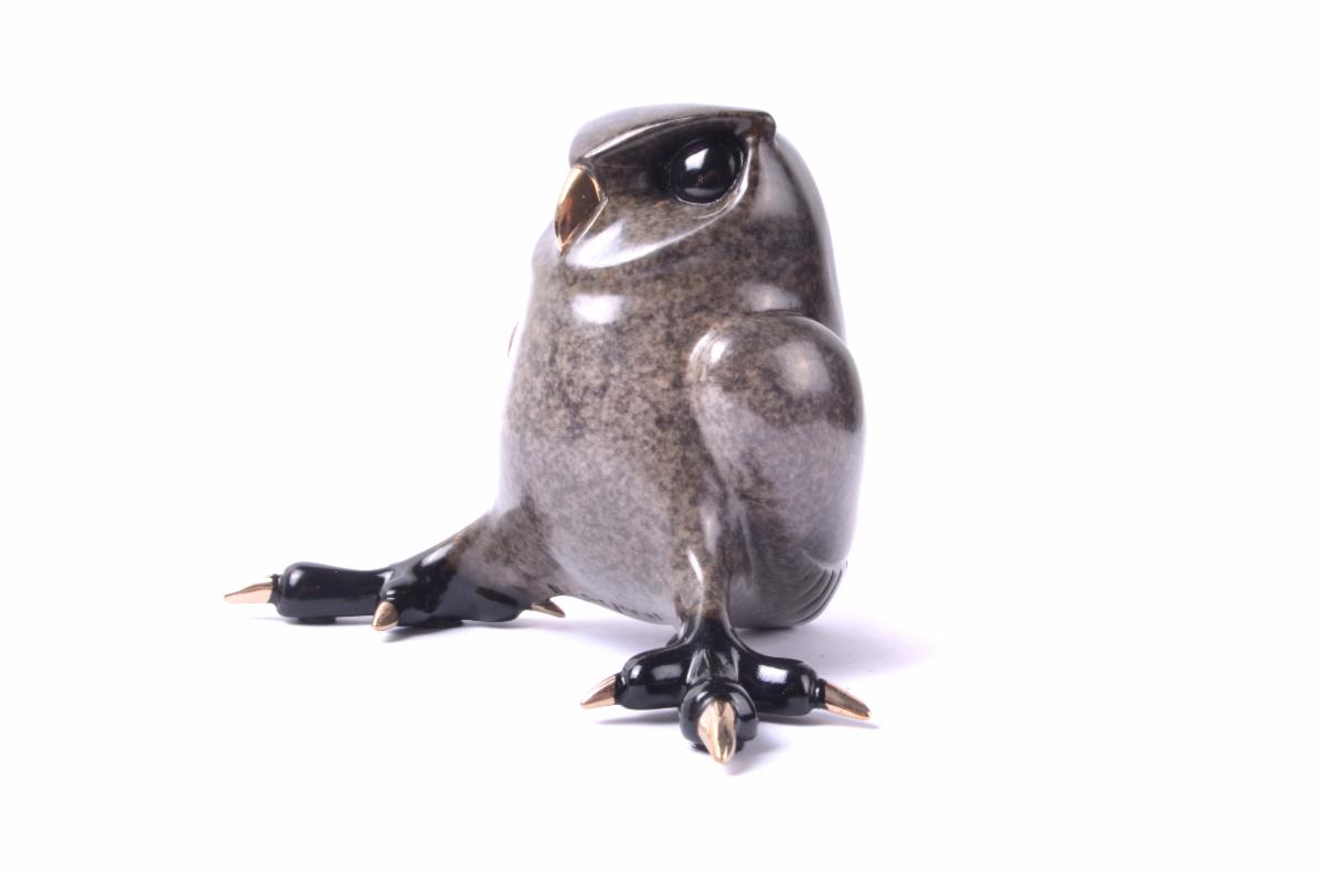 Bronson, a sleek, abstract bronze sculpture by Tim Cotterill, captures the essence of a bird. Its smooth dark finish stands out against a white backdrop, with art collectors admiring its rounded body and stylized pointed feet details.