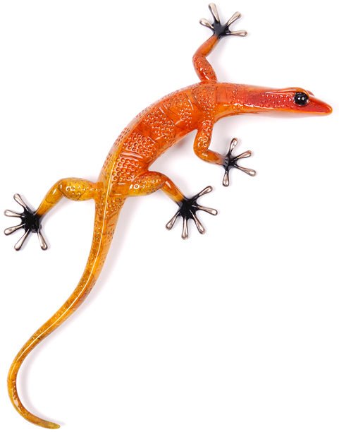 The Fuego is a bright orange, lizard-shaped plastic toy resembling a gecko sculpture. It features textured scales, large black eyes, and splayed toes, casting a subtle shadow on a white background.