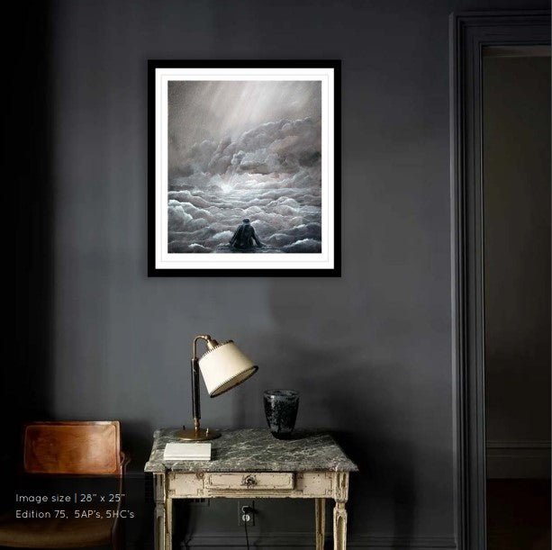 A dramatic giclée titled Hope, depicting a person amid clouds, hangs on a dark wall. Below it, a vintage desk with a lamp and decor contrasts the scene, echoing Mackenzie Thorpes evocative style.