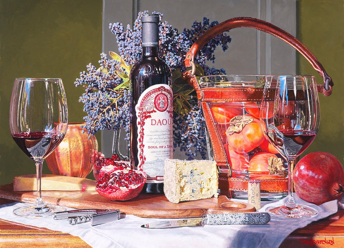 A still life shows two glasses of red wine, a bottle of Members Only, blue cheese, pomegranate, knife, corkscrew, and basket of persimmons on a table—an original watercolor in Eric Christensen’s style.