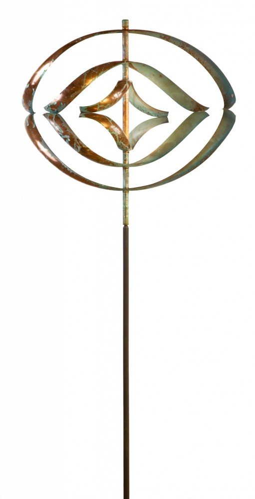 The Mirinda III is a metallic garden ornament resembling Lyman Whitakers wind sculptures. It features a tall, slender pole with a circular design on top, showcasing geometric shapes like a diamond within two curved ovals. It offers a weathered, rustic look, combining contemporary art with natural elegance.