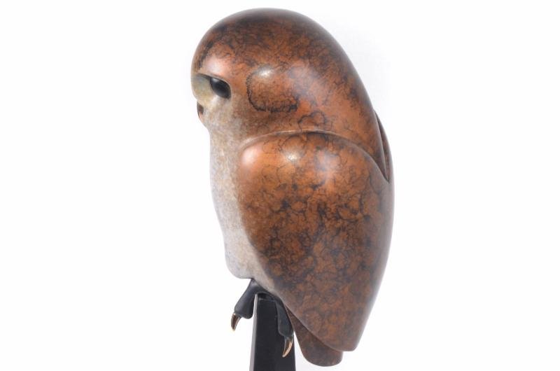 Napoleon—a smooth, polished bronze owl statue by Frogman—features a rounded body, natural mottled brown coloring, and perches on a stand; shown in side view against a white background.