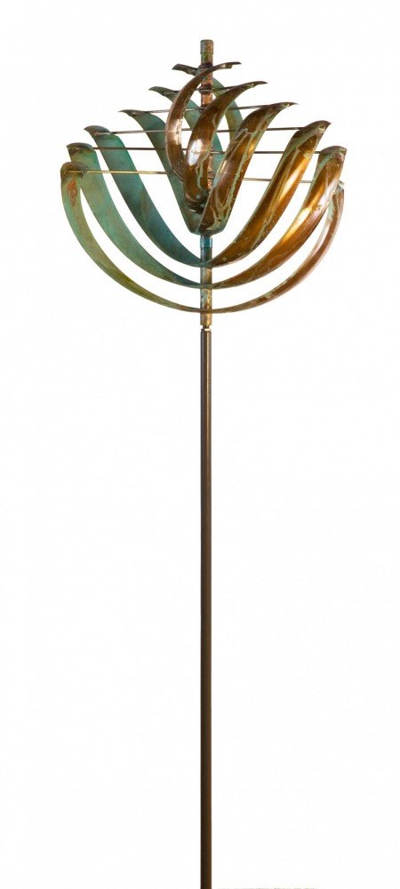 The Nautilus, a Lyman Whitaker copper kinetic wind sculpture, showcases stacked curved blades on a slender vertical pole. Its patina finish of green and brown hues beautifully captures both wind and artistry while subtly nodding to environmental issues.