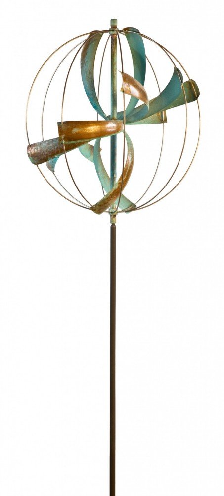 The Nebula sculpture, inspired by Lyman Whitaker art, features curved metal ribbons in green and copper hues. Encircled by a thin frame and mounted on a tall pole, it gracefully dances with every breeze.