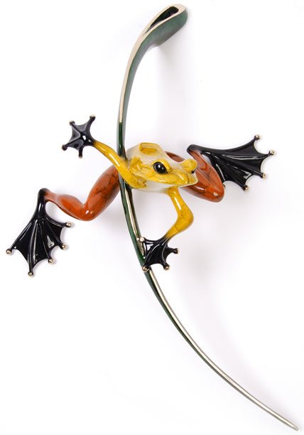 The Ready, Set, Go sculpture by Tim Cotterill features a vibrant multicolored frog with yellow, orange, and black hues clinging to a metallic vine. The bronze piece beautifully captures the essence of movement and agility with detailed webbed feet in a dynamic pose.