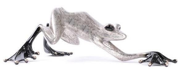 The Rocket is a sleek, metallic gray frog sculpture featuring a silver nitrate patina. Poised in a dynamic stretch, its elongated limbs and shiny black webbed feet bring a modern artistic flair, reminiscent of Tim Cotterills iconic style.