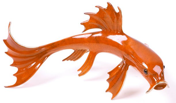 The Small Fry is a vibrant orange, glossy ceramic fish sculpture with flowing fins and graceful curves, capturing dynamic motion. Part of an aquatic-themed collection, it beautifully complements Frogman Bronze creations.
