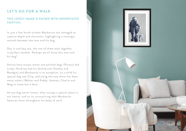 A modern living room with mint-green walls, white minimalist furniture, and a side table. Lets Go For A Walk, framed art of a man walking his dog in the snow, hangs on the wall with artist info about Mackenzie on the left.