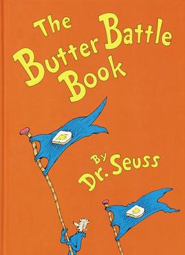 The cover of The Butter Battle Book by Dr. Seuss features two blue flags with bread and butter designs, held by white-haired characters in blue outfits, all set against a vibrant orange backdrop.