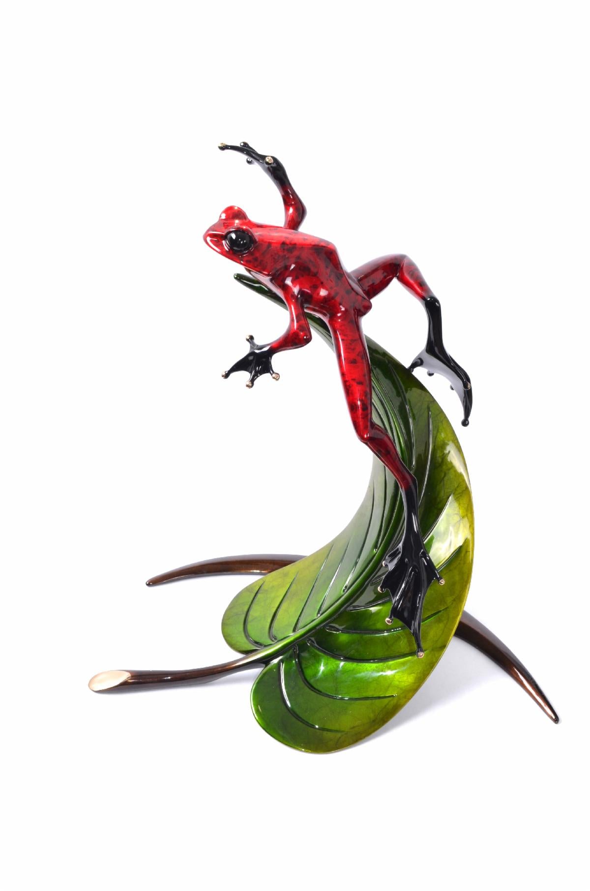 Zenith by Frogman Bronze features a shiny red frog standing on a curling green leaf with metallic brown stems, displayed against a white background.