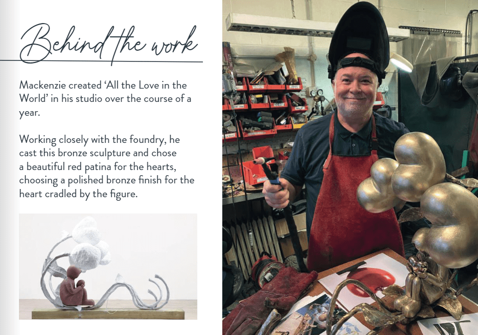 A smiling man in a welding helmet and red apron stands in a studio, holding a hammer beside a metal heart sculpture. An inset shows his finished work, All The Love In The World.