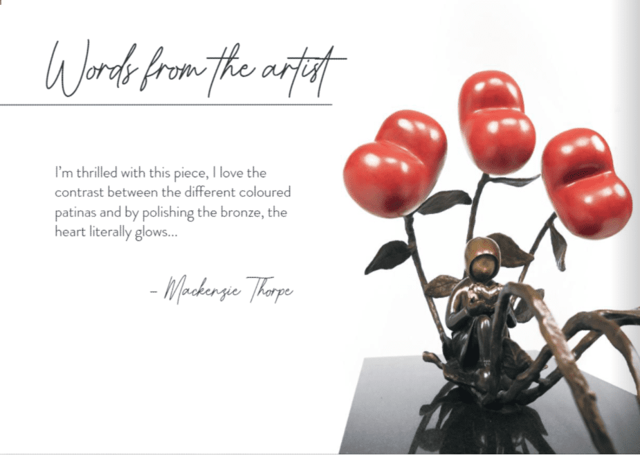 A bronze sculpture titled All The Love In The World features shiny red heart-shaped flowers above a small figure. Accompanied by Mackenzie Thorpes reflections, its a striking example of his art in the Lake Tahoe art district.