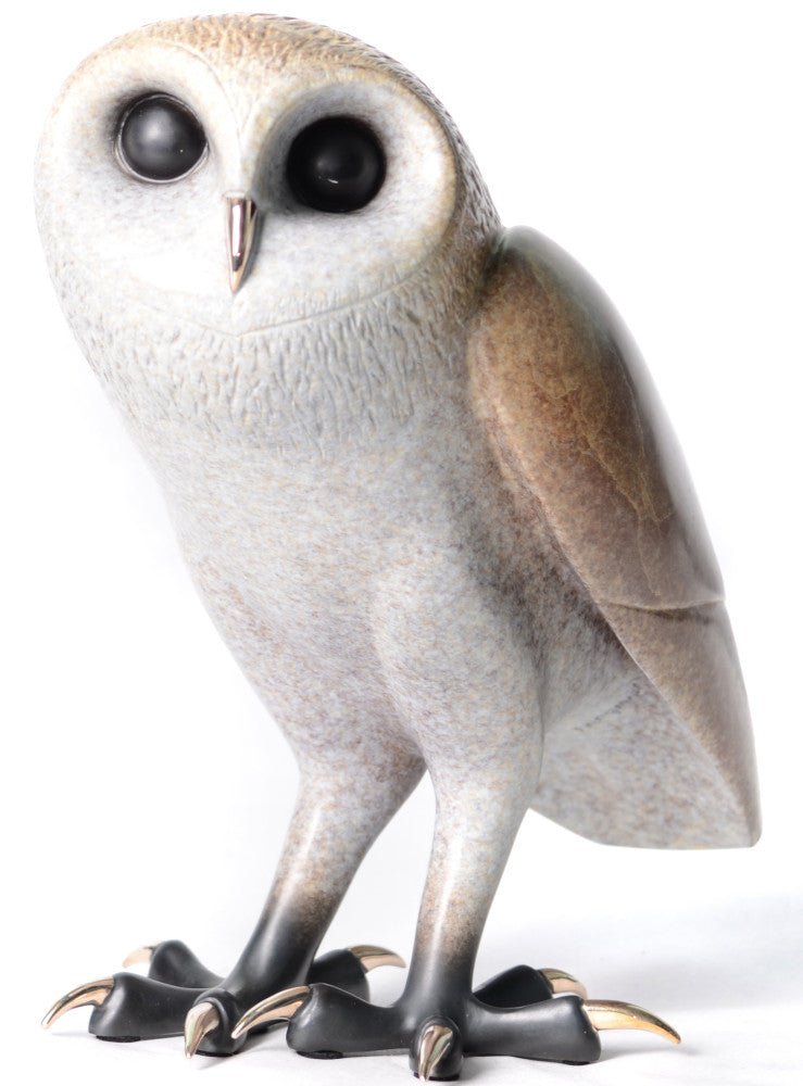 The Churchill porcelain owl statue features large, round black eyes, smooth light gray feathers, and detailed talons. Perched upright, it blends light and dark brown tones on its wings and body, reminiscent of a Tim Cotterill bronze sculpture.