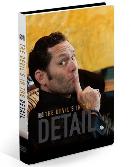 A dark-haired man, possibly a glamorous artist, leans back on a sofa while making a shushing gesture. Beside him is the book cover The Devils In The Detail - Todd White in bold yellow and black hues.