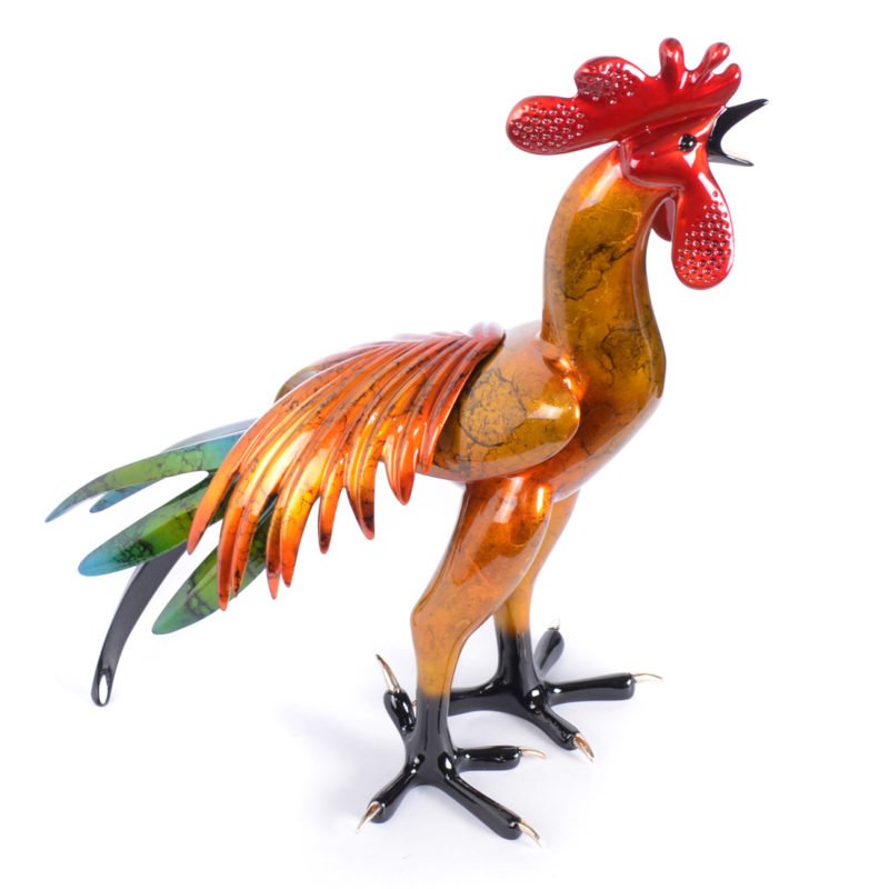 The Cocorico sculpture is a vibrant, multicolored rooster with a glossy finish, showcasing intricate orange, red, and blue detailing. This elegant Frogman art piece stands on black legs with an open beak.