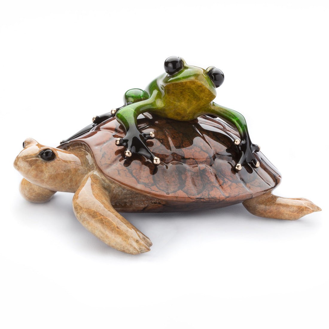 The Easy Rider sculpture, showcasing Frogman artistry, features a glossy green frog gracefully perched on a shiny brown turtle. Made from polished stone with a fine finish, the frogs front legs extend forward. This captivating piece shines against a plain white background.