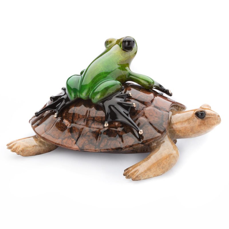 The Easy Rider by Tim Cotterill features a glossy green and black frog atop a detailed brown tortoise shell, crafted with materials that give it a stone-like appearance.