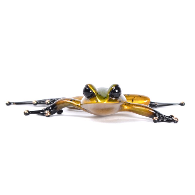 The exquisite Froglet glass sculpture, reminiscent of Frogman art by Tim Cotterill, features a shiny golden body and elongated black legs. Set against a white background, its smooth and reflective form showcases the artistry celebrated at Marcus Ashley Gallery.