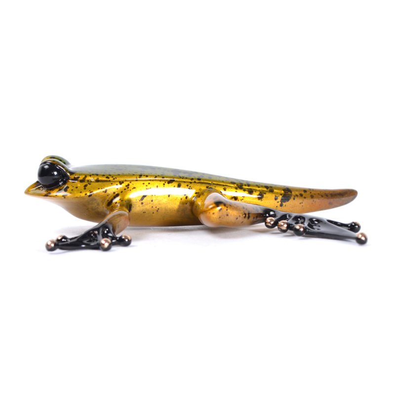 The Froglet is a realistic glass gecko sculpture similar to Tim Cotterill designs at Marcus Ashley Gallery, featuring a metallic gold body with black speckles. Its large bulbous eyes and splayed toes shine brilliantly against the white backdrop.