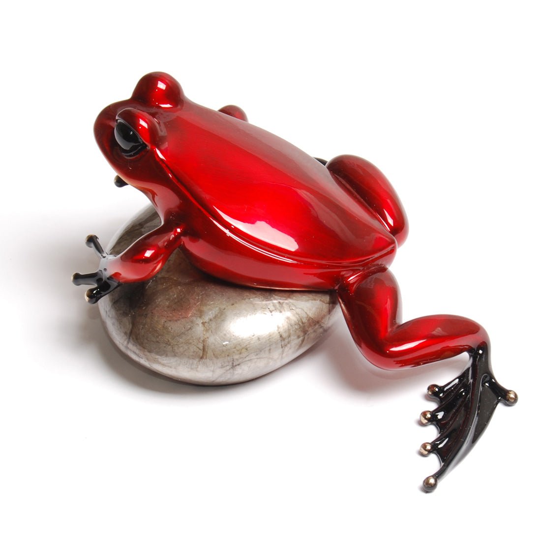 The Rockefeller sculpture presents a shiny red frog with black feet on a smooth, metallic stone, embodying Frogman arts iconic style. Its glossy finish harkens to those exhibited at the Marcus Ashley Gallery.