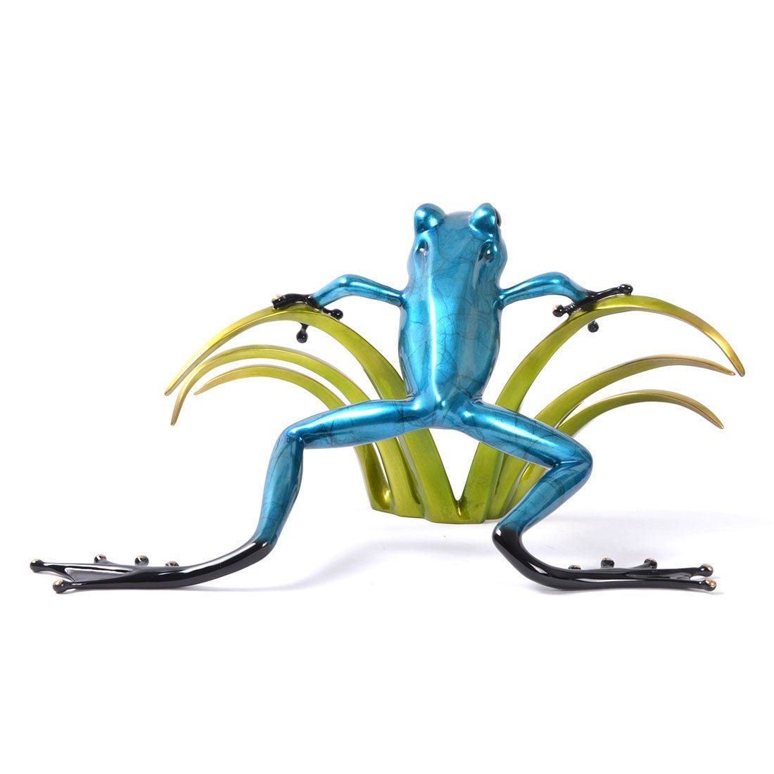 The Sherlock, a striking blue frog sculpture with elongated limbs and a glossy finish, reminiscent of Frogman art, is posed against stylized green plants. Its vibrant color and intricate design beautifully contrast with the plain white background.