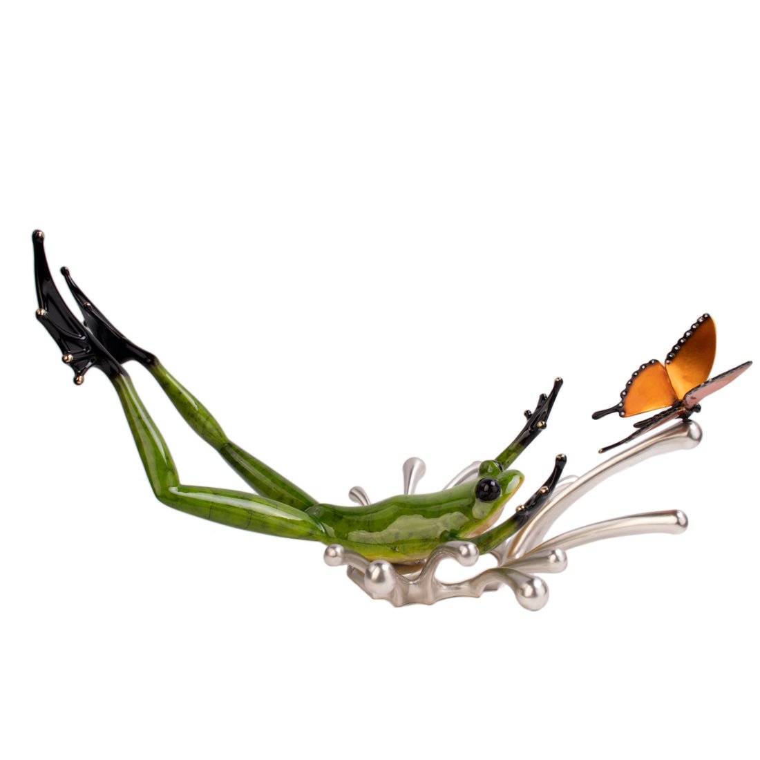 The glass sculpture Splashdown by Frogman art, showcased at Marcus Ashley Gallery near Lake Tahoe, depicts a green frog leaping upward with elegant elongated limbs toward an orange butterfly, capturing dynamic mid-air movement.