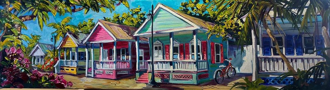 Key Cottages features tropical houses with vibrant pink, blue, and green facades on a sunny street. Surrounded by lush greenery and palm trees, a bicycle rests against one cottage under the bright blue sky, creating a picturesque scene reminiscent of Steve Barton art.