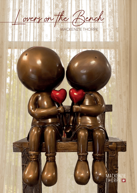 Two bronze, round-headed figures sit on a bench holding red hearts. This expressive sculpture, Lovers on the Bench, is by Mackenzie Thorpe and featured at Marcus Ashley Gallery.