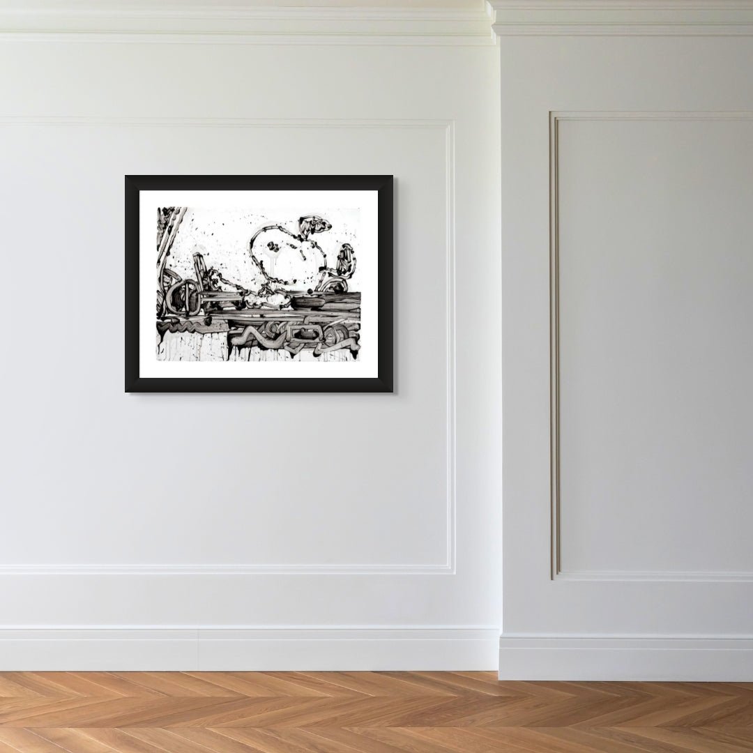 Maxi Taxi, a framed black-and-white abstract artwork inspired by Tom Everhart’s contemporary style, is displayed on a white wall with decorative molding and light wood herringbone flooring in a minimalist room.
