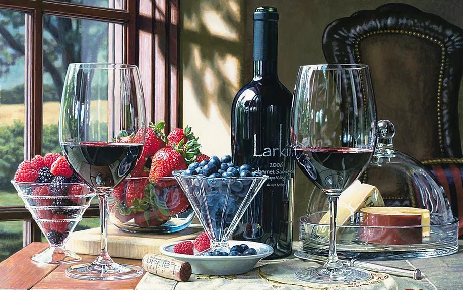 A table showcasing the Shades of Summer scene: two glasses and a Larkin Cabernet Sauvignon bottle, bowls of strawberries, raspberries, blueberries, a cheese platter beneath a glass dome, and a cork. Sunlight pours through the window like an Eric Christensen masterpiece.