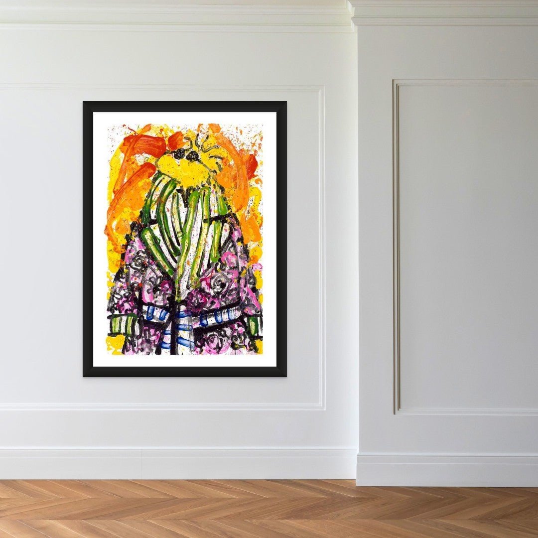 The Shorty Wearing Jim Dine / Exhibition Edition, a modern art piece echoing Woodstocks vibrant energy, decorates a white wall. Its abstract design bursts with bright yellow, orange, green, and purple hues. The pieces expressive style is complemented by the rooms wooden floor and minimalist decor.