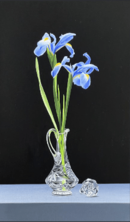 The product Still Life with Irises features a clear vase with three blooming blue irises with long green stems against a black background, echoing the serenity in Alexander Volkovs art, accompanied by a small crystal sphere on a light blue surface for an added touch of soul medicine.