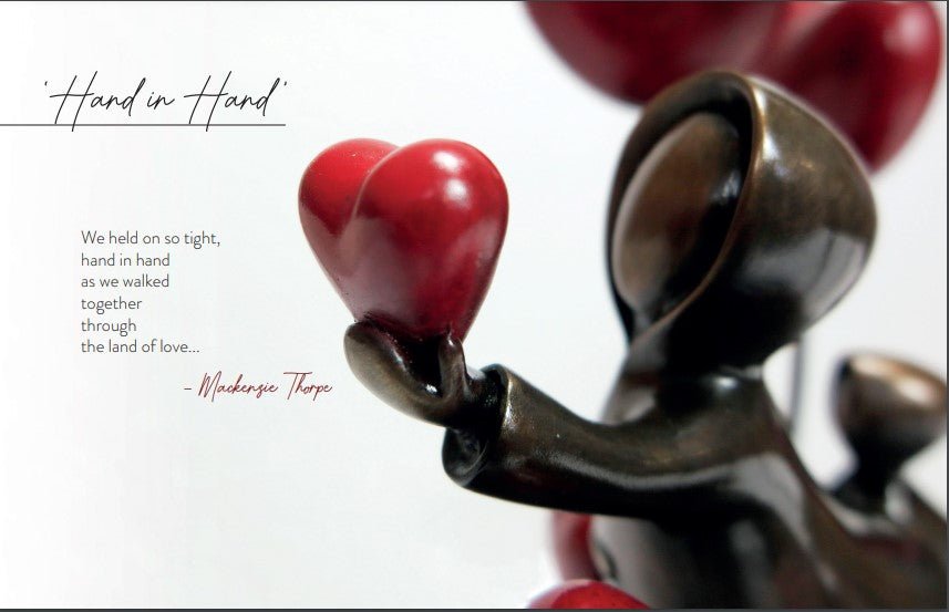 A sculpture titled Hand in Hand features a figure holding a red heart on a white background, accompanied by Mackenzie Thorpes quote about walking hand in hand through the land of love.