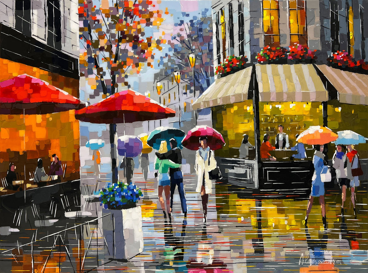 People with umbrellas walk along a rain-soaked street lined with cafes. Bright red umbrellas cover tables, and warm lights glow from the buildings, offering an Evening Embrace. Autumn leaves add color to the scene, with the ground reflecting vibrant hues like an Aleksandra Rozenvain painting.