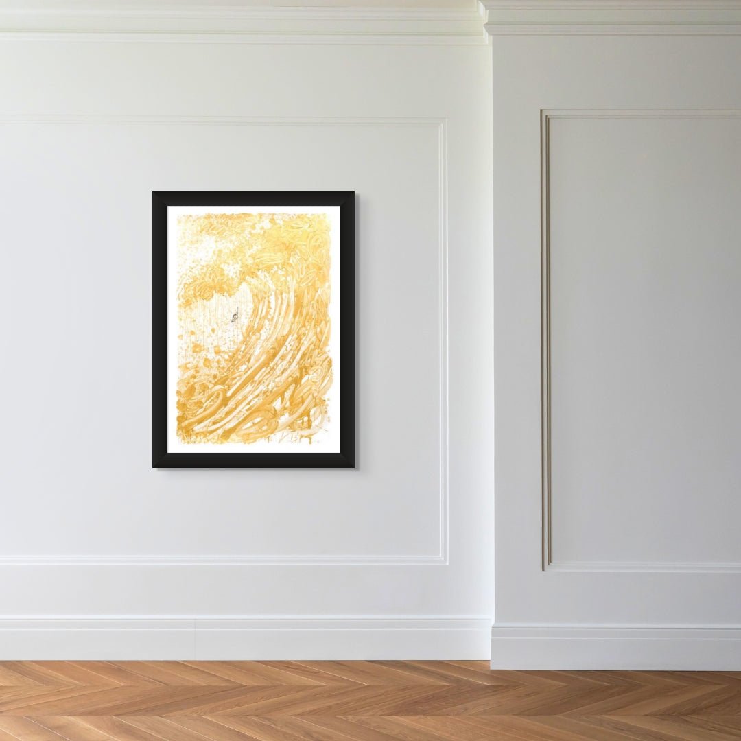 The Venice Moon Dogg E 3, a framed abstract painting with gold swirls on a white background reminiscent of Tom Everharts style, is mounted on a decoratively paneled white wall in a room ideal for art lovers, featuring herringbone wood flooring and minimalistic decor.