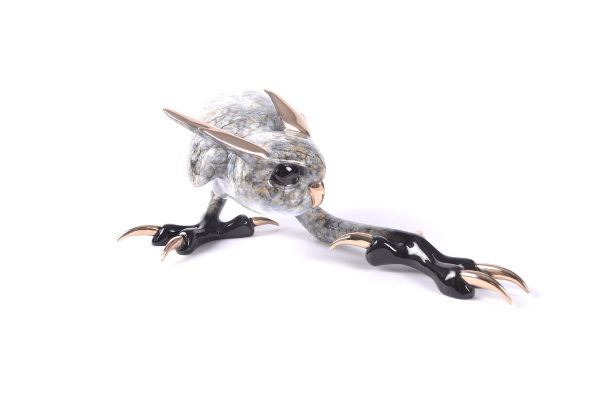 Zeus is a stylized bird sculpture featuring a marble-textured body, gold beak and ears, and oversized black claws, exuding majesty against a plain white background.
